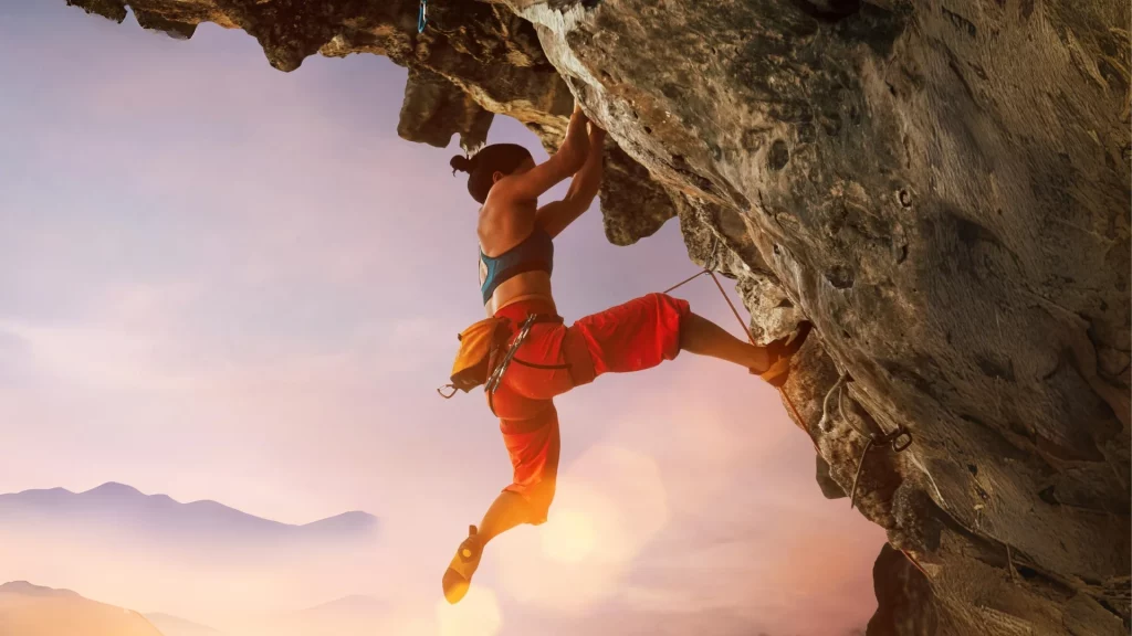 Asian woman resiliently climbing a mountain